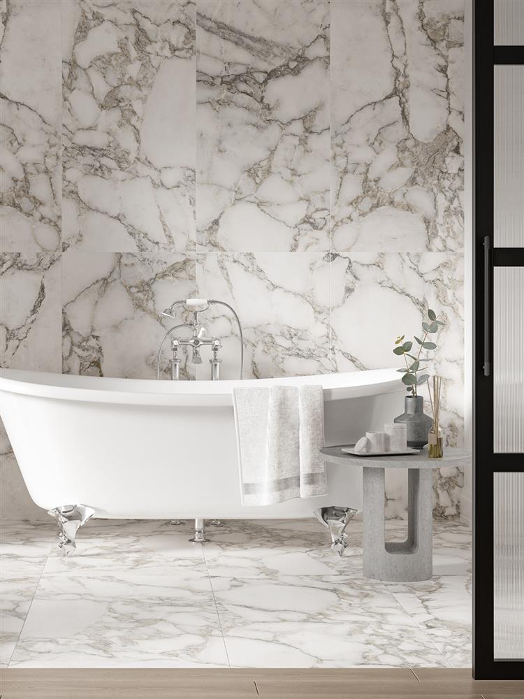 Grey veined marble white tiles in a stylish bathroom with a freestanding bath